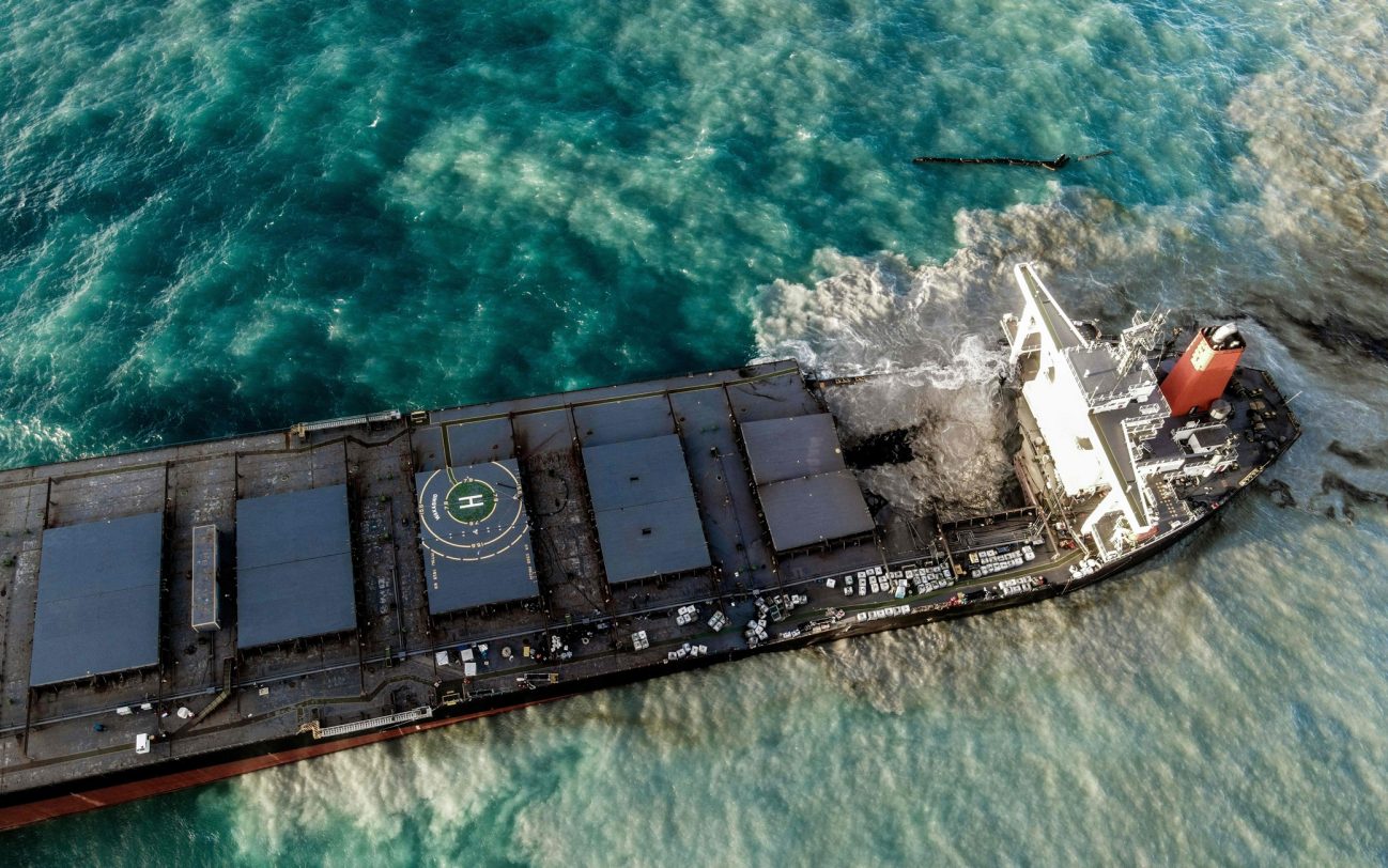An aerial view taken on August 15, 2020 shows the vessel MV Wakashio, belonging to a Japanese company but Panamanian-flagged that had run aground near Blue Bay Marine Park, Mauritius three weeks ago. - A fresh streak of oil spilled on August 14, 2020, from a ship stranded on a reef in pristine waters off Mauritius, threatening further ecological devastation as demands mount for answers as to why the vessel had come so close to shore. (Photo by STRINGER / AFP) / The erroneous mention[s] appearing in the metadata of this photo by STRINGER has been modified in AFP systems in the following manner: Source IPTC should read [AFP] instead of [L'Express Maurice]. Please immediately remove the erroneous mention[s] from all your online services and delete it (them) from your servers. If you have been authorized by AFP to distribute it (them) to third parties, please ensure that the same actions are carried out by them. Failure to promptly comply with these instructions will entail liability on your part for any continued or post notification usage. Therefore we thank you very much for all your attention and prompt action. We are sorry for the inconvenience this notification may cause and remain at your disposal for any further information you may require. (Photo by STRINGER/AFP via Getty Images)