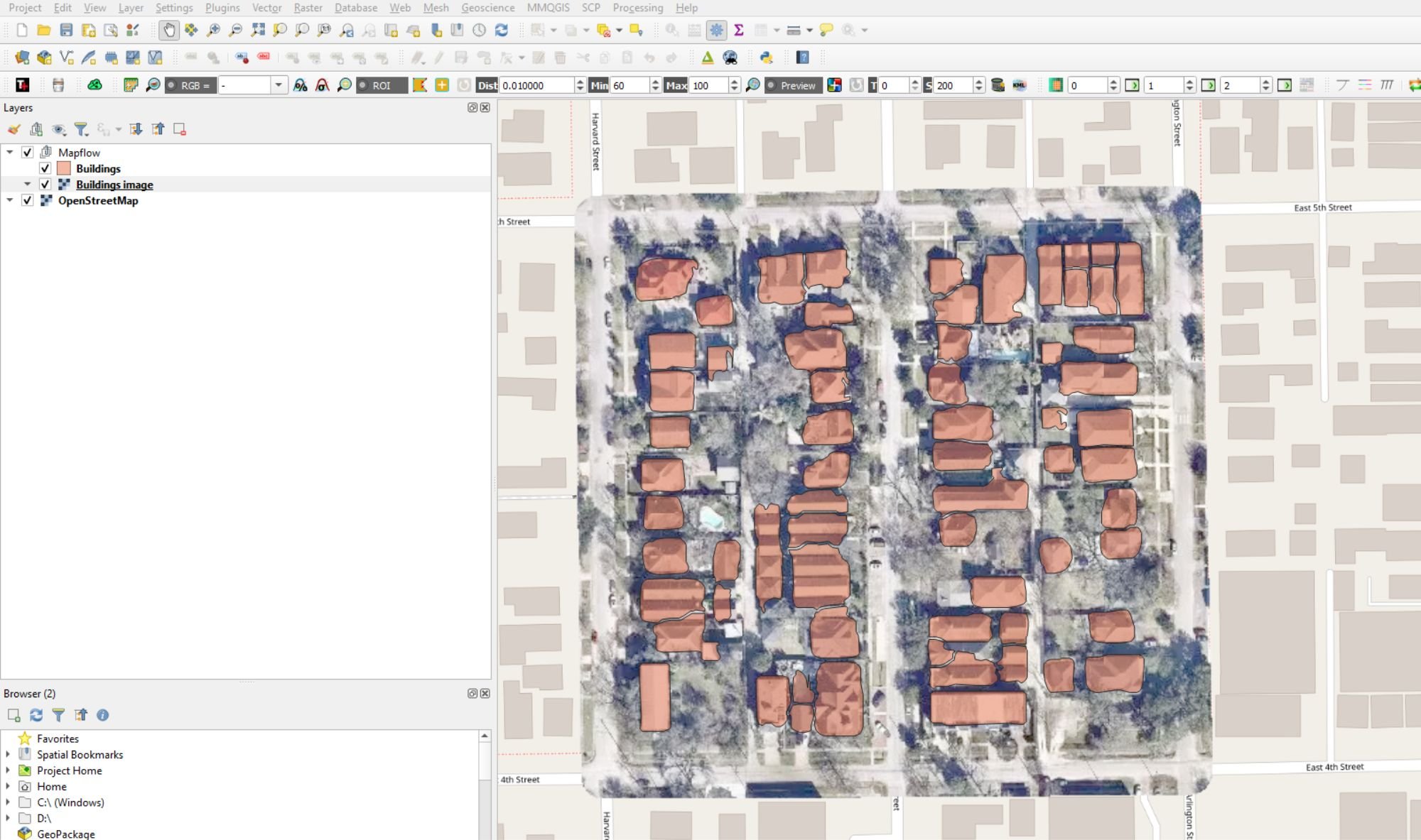 A screenshot of a QGIS map project with building footprints in medium orange over a clipped aerial image.