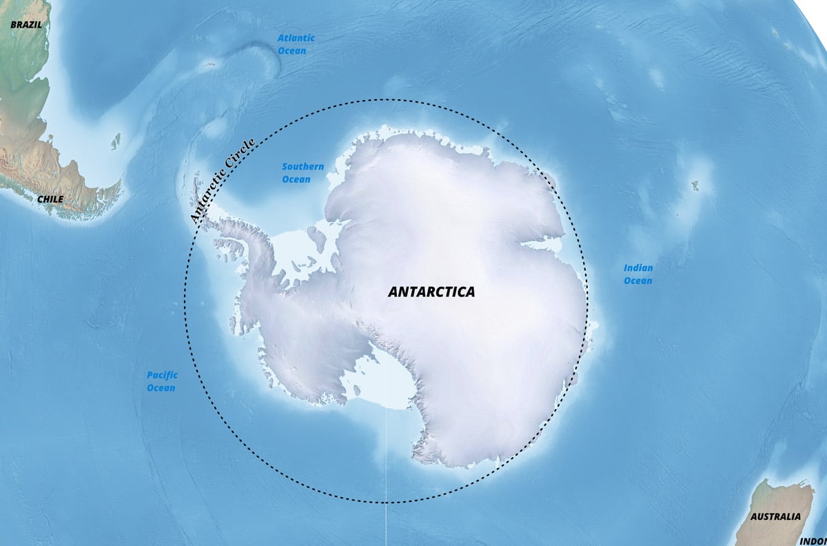 Shaded relief map with a black dashed line showing the Antarctic Circle in the South Pole orthographic projection.